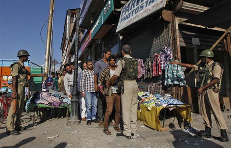 Indian police frisk a Kashmiri man during a cordon and search operation ahead of a concert by the Bavarian State Orchestra and renowned cond Indian police frisk a Kashmiri man during a cordon and search operation ahead of a concert by the Bavarian State Orchestra and renowned cond