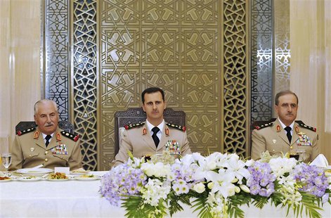 Syria's President Bashar al-Assad (C) attends a dinner with Defense Minister General Ali Habib (L) and Chief of Staff General Dawoud Rajhain Syria's President Bashar al-Assad (C) attends a dinner with Defense Minister General Ali Habib (L) and Chief of Staff General Dawoud Rajhain