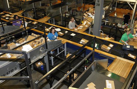 United Parcel Service employees sort packages at the UPS Worldport All Points International Hub during the peak delivery day in Louisville, United Parcel Service employees sort packages at the UPS Worldport All Points International Hub during the peak delivery day in Louisville,