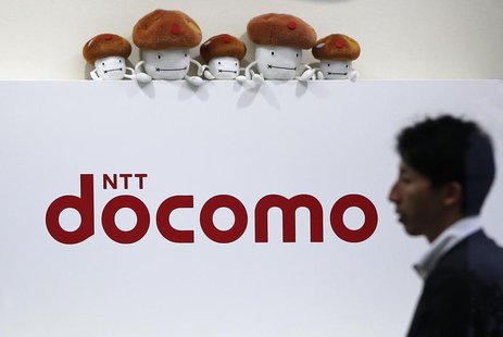 A man walks past the logo of Japan's biggest mobile phone operator NTT Docomo at its shop in Tokyo July 3, 2013. REUTERS/Issei Kato A man walks past the logo of Japan's biggest mobile phone operator NTT Docomo at its shop in Tokyo July 3, 2013. REUTERS/Issei Kato