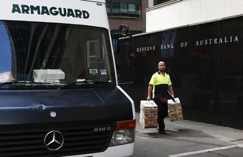 A worker carries boxes next to an armoured vehicle parked in front of the Reserve Bank of Australia in central Sydney September 3, 2013. REU A worker carries boxes next to an armoured vehicle parked in front of the Reserve Bank of Australia in central Sydney September 3, 2013. REU