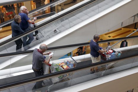 Customers push shopping trolleys on an escalator at the Bercy shopping centre in Charenton Le Pont, near Paris, August 29, 2013. REUTERS/Cha Customers push shopping trolleys on an escalator at the Bercy shopping centre in Charenton Le Pont, near Paris, August 29, 2013. REUTERS/Cha