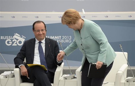 German Chancellor Angela Merkel (R) and French President Francois Hollande attend a meeting with business leaders in St.Petersburg September German Chancellor Angela Merkel (R) and French President Francois Hollande attend a meeting with business leaders in St.Petersburg September