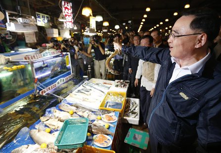 South Korea's Prime Minister Jung Hong-won holds up a domestic fish during his visit to the Noryangjin fisheries wholesale market in Seoul S South Korea's Prime Minister Jung Hong-won holds up a domestic fish during his visit to the Noryangjin fisheries wholesale market in Seoul S