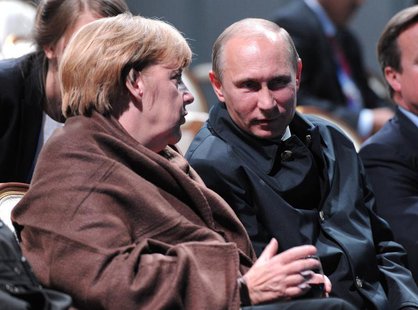 Russian President Vladimir Putin (R) and German Chancellor Angela Merkel talk as they watch a fragment from the ballet "Ruslan and Lyudmila" Russian President Vladimir Putin (R) and German Chancellor Angela Merkel talk as they watch a fragment from the ballet "Ruslan and Lyudmila"