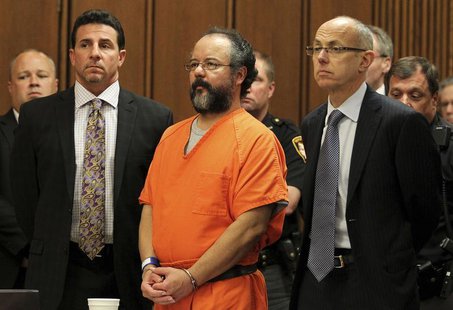Ariel Castro (C), 53, stands between attorneys Craig Weintraub (L) and Jaye Schlachet as his sentence is read to him by judge Michael J. Rus Ariel Castro (C), 53, stands between attorneys Craig Weintraub (L) and Jaye Schlachet as his sentence is read to him by judge Michael J. Rus