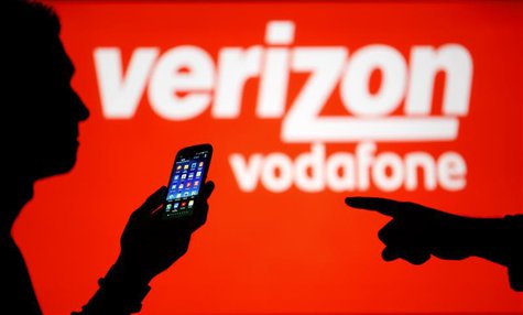 A man is silhouetted against a video screen with Vodafone and Verizon texts as he poses with a Samsung Galaxy S3 in this photo illustration A man is silhouetted against a video screen with Vodafone and Verizon texts as he poses with a Samsung Galaxy S3 in this photo illustration