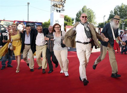 Director Gianfranco Rosi (2nd R) poses with his cast during a red carpet for the movie "Sacro Gra" at the 70th Venice Film Festival Septembe Director Gianfranco Rosi (2nd R) poses with his cast during a red carpet for the movie "Sacro Gra" at the 70th Venice Film Festival Septembe