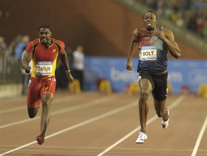 Usain Bolt of Jamaica (R) runs next to Justin Gatlin of the U.S. on his way to win the men's 100 metres during the IAAF Diamond League athle Usain Bolt of Jamaica (R) runs next to Justin Gatlin of the U.S. on his way to win the men's 100 metres during the IAAF Diamond League athle