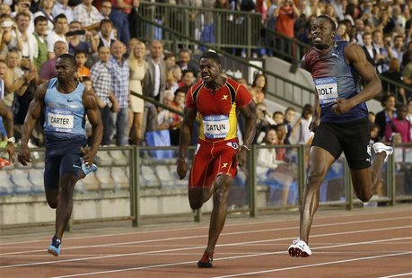 Usain Bolt of Jamaica (R) runs next to Nesta Carter of Jamaica (L) and Justin Gatlin of the U.S. on his way to win the men's 100 metres duri Usain Bolt of Jamaica (R) runs next to Nesta Carter of Jamaica (L) and Justin Gatlin of the U.S. on his way to win the men's 100 metres duri