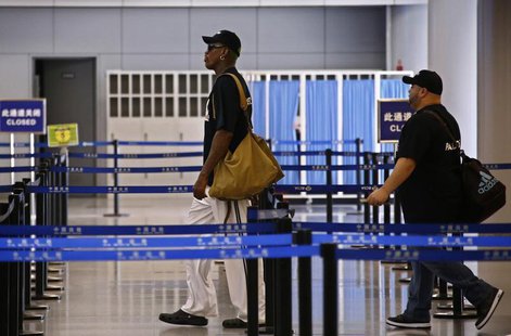 Former basketball star Dennis Rodman walks towards China's Frontier Inspection point as he transits to Pyongyang from Beijing Capital Intern Former basketball star Dennis Rodman walks towards China's Frontier Inspection point as he transits to Pyongyang from Beijing Capital Intern