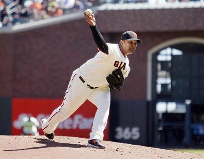 San Francisco Giants pitcher Yusmeiro Petit winds up during the second inning of his MLB exhibition baseball game against the Oakland Athlet San Francisco Giants pitcher Yusmeiro Petit winds up during the second inning of his MLB exhibition baseball game against the Oakland Athlet