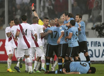 Peru and Uruguay players scuffle after the referee sends off Peru's Victor Yotun (not pictured) with a red card during their 2014 World Cup Peru and Uruguay players scuffle after the referee sends off Peru's Victor Yotun (not pictured) with a red card during their 2014 World Cup