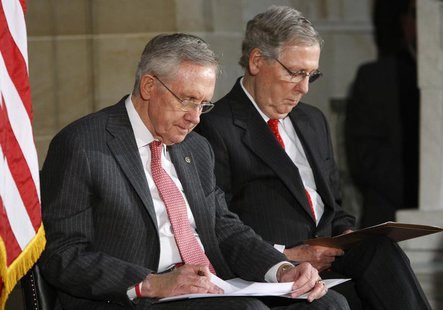 U.S. Senate Majority Leader Harry Reid (D-NV) (L) and Senate Minority Leader Mitch McConnell (R-KY) (R) look at their notes during a ceremon U.S. Senate Majority Leader Harry Reid (D-NV) (L) and Senate Minority Leader Mitch McConnell (R-KY) (R) look at their notes during a ceremon