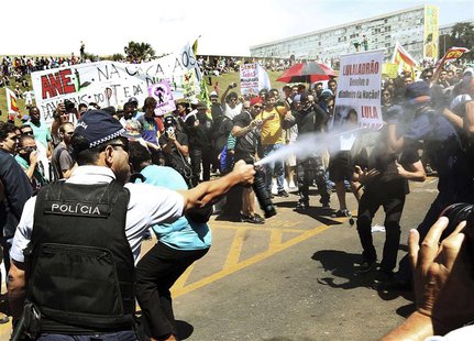 A policeman sprays anti-government demonstrators with tear gas outside the Congress in Brasilia, September 7, 2013. REUTERS/Gregg Newton A policeman sprays anti-government demonstrators with tear gas outside the Congress in Brasilia, September 7, 2013. REUTERS/Gregg Newton