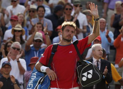 Stanislas Wawrinka of Switzerland waves as he departs the court after being defeated by Novak Djokovic of Serbia in their men's semi-final m Stanislas Wawrinka of Switzerland waves as he departs the court after being defeated by Novak Djokovic of Serbia in their men's semi-final m