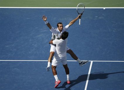 Leander Paes (R) of India and Radek Stepanek of the Czech Republic celebrate winning match point against Bob and Mike Bryan of the U.S. in t Leander Paes (R) of India and Radek Stepanek of the Czech Republic celebrate winning match point against Bob and Mike Bryan of the U.S. in t