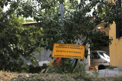 A sign which reads, "Prohibited to enter. Under close weapon surveillance" at an orchard confiscated from the Camorra clan, or the local maf A sign which reads, "Prohibited to enter. Under close weapon surveillance" at an orchard confiscated from the Camorra clan, or the local maf