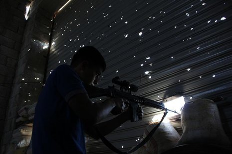 A Free Syrian Army fighter points his weapon as he tries to locate forces loyal to Syria's President Bashar al-Assad in Ramouseh area in Ale A Free Syrian Army fighter points his weapon as he tries to locate forces loyal to Syria's President Bashar al-Assad in Ramouseh area in Ale
