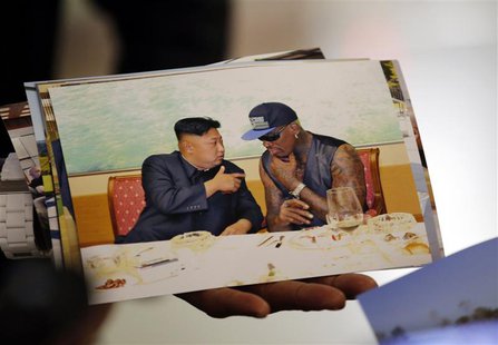 Former basketball star Dennis Rodman of the U.S. shows a picture which he took with North Korean leader Kim Jong-un as he arrives at Beijing Former basketball star Dennis Rodman of the U.S. shows a picture which he took with North Korean leader Kim Jong-un as he arrives at Beijing