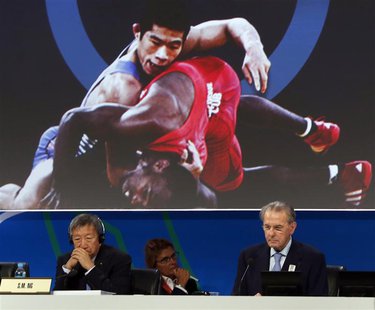 President of the International Olympic Committee (IOC) Jacques Rogge (R) listens to the presentation of wrestling to be included as an Olymp President of the International Olympic Committee (IOC) Jacques Rogge (R) listens to the presentation of wrestling to be included as an Olymp