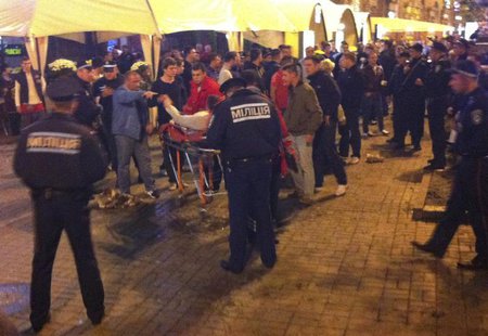 A photo, taken with a mobile phone, shows an injured English soccer fan lying on a stretcher and surrounded by medical personnel, police and A photo, taken with a mobile phone, shows an injured English soccer fan lying on a stretcher and surrounded by medical personnel, police and