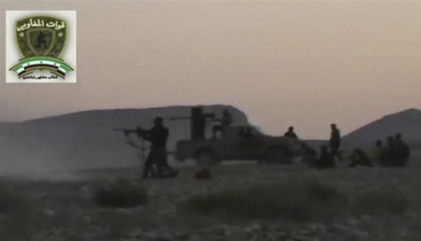 Syrian rebels from the "Maghawir of Baba Amer" and "Baba Amer Revolutionaries" brigades exchange gunfire with Syrian government forces at a Syrian rebels from the "Maghawir of Baba Amer" and "Baba Amer Revolutionaries" brigades exchange gunfire with Syrian government forces at a