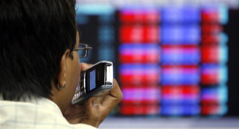 A stockbroker speaks on a mobile phone as he looks at a terminal while trading at a stock brokerage firm in Mumbai October 27, 2008. REUTERS A stockbroker speaks on a mobile phone as he looks at a terminal while trading at a stock brokerage firm in Mumbai October 27, 2008. REUTERS