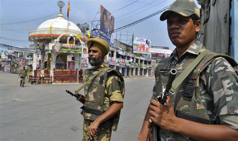 Soldiers stand guard on a deserted street during a curfew in Muzaffarnagar, 127 km (80 miles) northeast of New Delhi in the state of Uttar P Soldiers stand guard on a deserted street during a curfew in Muzaffarnagar, 127 km (80 miles) northeast of New Delhi in the state of Uttar P