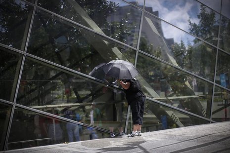A visitor to the 911 Memorial plaza peers through glass windows into the 911 Memorial Museum, which is under construction, at the World Trad A visitor to the 911 Memorial plaza peers through glass windows into the 911 Memorial Museum, which is under construction, at the World Trad