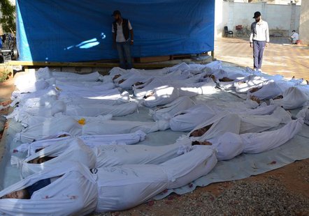 ATTENTION EDITORS - VISUALS COVERAGE OF SCENES OF DEATH AND INJURY Syrian activists inspect the bodies of people they say were killed by ner ATTENTION EDITORS - VISUALS COVERAGE OF SCENES OF DEATH AND INJURY Syrian activists inspect the bodies of people they say were killed by ner