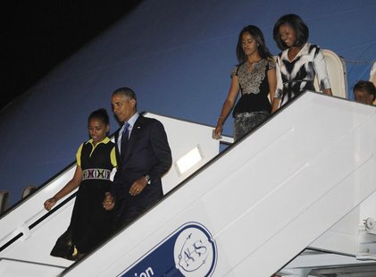 U.S. President Barack Obama (2nd L) and first lady Michelle Obama (R ) arrive with their daughters Sasha (L) and Malia in Dakar, June 26, 20 U.S. President Barack Obama (2nd L) and first lady Michelle Obama (R ) arrive with their daughters Sasha (L) and Malia in Dakar, June 26, 20
