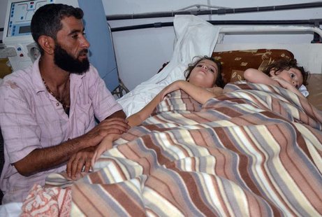 A man sits in a hospital near two children who activists say were affected by nerve gas in the Ghouta region, in the Duma neighbourhood of D A man sits in a hospital near two children who activists say were affected by nerve gas in the Ghouta region, in the Duma neighbourhood of D