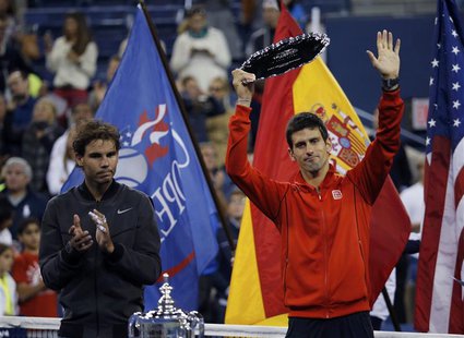 Rafael Nadal of Spain applauds as Novak Djokovic of Serbia raises his runner up trophy after Nadal won their men's final match at the U.S. O Rafael Nadal of Spain applauds as Novak Djokovic of Serbia raises his runner up trophy after Nadal won their men's final match at the U.S. O