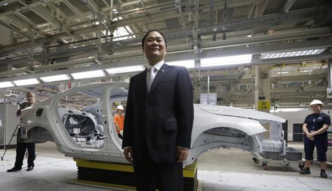 Chairman of Zhejiang Geely Holding Group Li Shufu poses for a photo at an assembly line of the new Volvo automobile manufacturing plant in C Chairman of Zhejiang Geely Holding Group Li Shufu poses for a photo at an assembly line of the new Volvo automobile manufacturing plant in C