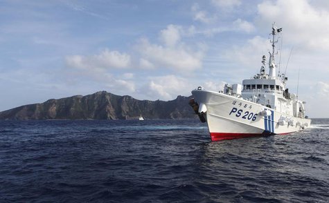 Japan Coast Guard vessel PS206 Houou sails in front of Uotsuri island, one of the disputed islands, called Senkaku in Japan and Diaoyu in Ch Japan Coast Guard vessel PS206 Houou sails in front of Uotsuri island, one of the disputed islands, called Senkaku in Japan and Diaoyu in Ch
