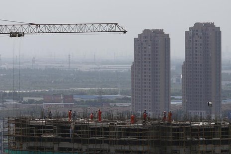 Construction workers are seen on a building in Shanghai September 4, 2013. REUTERS/Aly Song Construction workers are seen on a building in Shanghai September 4, 2013. REUTERS/Aly Song