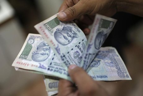 An employee counts Indian rupee currency notes inside a private money exchange office in New Delhi July 5, 2013. REUTERS/Adnan Abidi An employee counts Indian rupee currency notes inside a private money exchange office in New Delhi July 5, 2013. REUTERS/Adnan Abidi