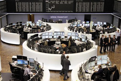 Traders are pictured at their desks in front of the German share price index DAX board at the Frankfurt stock exchange September 9, 2013. RE Traders are pictured at their desks in front of the German share price index DAX board at the Frankfurt stock exchange September 9, 2013. RE