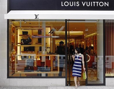 A woman exits the Louis Vuitton shop on New Bond Street, renowned for its jewellery and designer retailers, in London August 24, 2009. REUTE A woman exits the Louis Vuitton shop on New Bond Street, renowned for its jewellery and designer retailers, in London August 24, 2009. REUTE