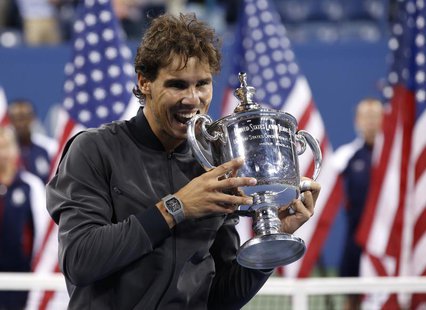 Rafael Nadal of Spain bites his trophy after defeating Novak Djokovic of Serbia in their men's final match at the U.S. Open tennis champions Rafael Nadal of Spain bites his trophy after defeating Novak Djokovic of Serbia in their men's final match at the U.S. Open tennis champions