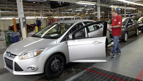 A Ford Motor assembly worker inspects the new 2012 Ford Focus vehicles on the final production line at Michigan Assembly Plant in Wayne, Mic A Ford Motor assembly worker inspects the new 2012 Ford Focus vehicles on the final production line at Michigan Assembly Plant in Wayne, Mic