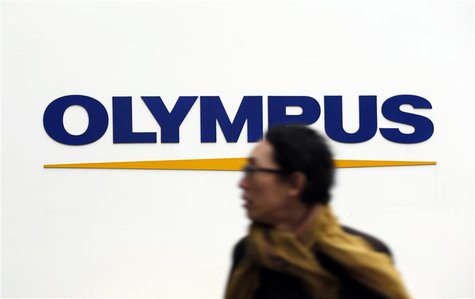 A man passes a logo of Olympus Corp outside the company's showroom in Tokyo December 21, 2012. Olympus and Sony Corp said on Friday that a p A man passes a logo of Olympus Corp outside the company's showroom in Tokyo December 21, 2012. Olympus and Sony Corp said on Friday that a p