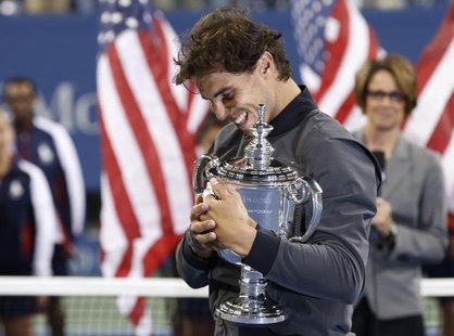 Rafael Nadal of Spain embraces his trophy after defeating Novak Djokovic of Serbia in their men's final match at the U.S. Open tennis champi Rafael Nadal of Spain embraces his trophy after defeating Novak Djokovic of Serbia in their men's final match at the U.S. Open tennis champi