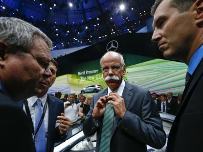 Daimler Chief Executive Dieter Zetsche (C) adjusts his tie during the presentation of the new SUV Mercedes GLA on a media preview day at the Daimler Chief Executive Dieter Zetsche (C) adjusts his tie during the presentation of the new SUV Mercedes GLA on a media preview day at the
