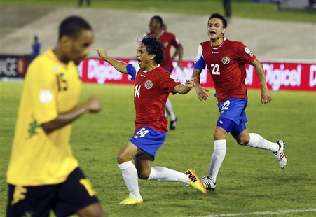 Costa Rica's Randall Brenes (C) celebrates his goal with teammate Jose Miguel Cubero (R) as Jamaica's Shaun Cummings returns to position dur Costa Rica's Randall Brenes (C) celebrates his goal with teammate Jose Miguel Cubero (R) as Jamaica's Shaun Cummings returns to position dur