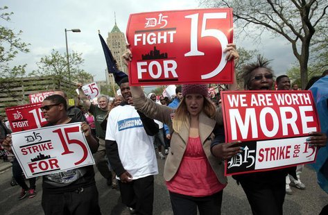 A group of workers and labor activists march down West Grand Boulevard as they demand a raise in the minimum wage for fast food workers in D A group of workers and labor activists march down West Grand Boulevard as they demand a raise in the minimum wage for fast food workers in D