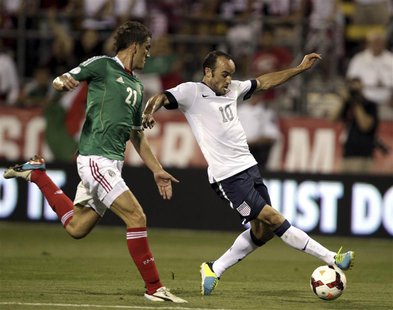 United States' Landon Donovan (10) fights for the ball with Mexico's Hiram Mier (21) during the first half of their 2014 World Cup qualifyin United States' Landon Donovan (10) fights for the ball with Mexico's Hiram Mier (21) during the first half of their 2014 World Cup qualifyin