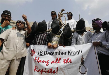 Demonstrators with their heads covered by black cloth take part in a protest outside a court in New Delhi September 10, 2013. REUTERS/Adnan Demonstrators with their heads covered by black cloth take part in a protest outside a court in New Delhi September 10, 2013. REUTERS/Adnan