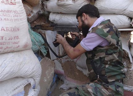 A Free Syrian Army fighter aims his weapon behind sandbags in the eastern al-Ghouta, near Damascus, September 9, 2013. Picture taken Septemb A Free Syrian Army fighter aims his weapon behind sandbags in the eastern al-Ghouta, near Damascus, September 9, 2013. Picture taken Septemb